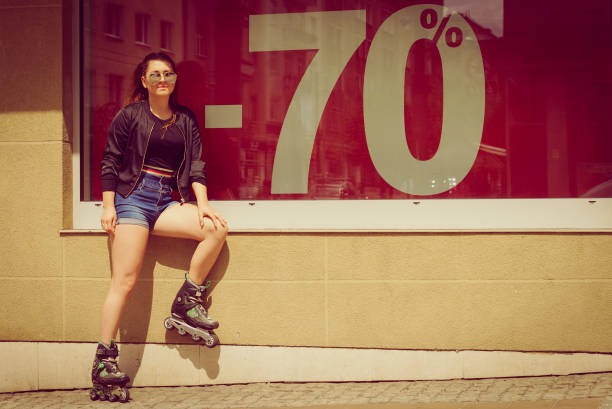 istock Woman wearing roller skates next to sale 1206248949