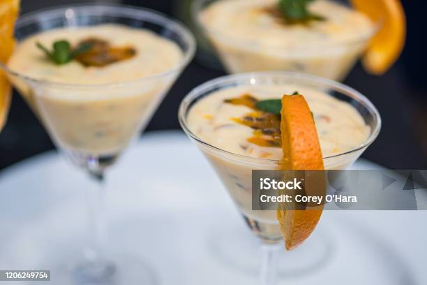 Bright Passion Fruit Mousse Decorated With Orange Slice Stock Photo - Download Image Now