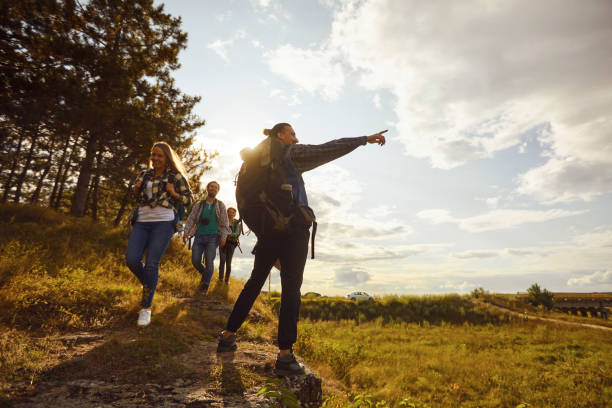 istock Young people with backpacks walking in the forest 1206251427