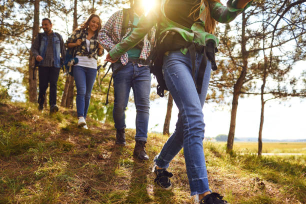 istock Young people with backpacks walking in the forest 1206251429