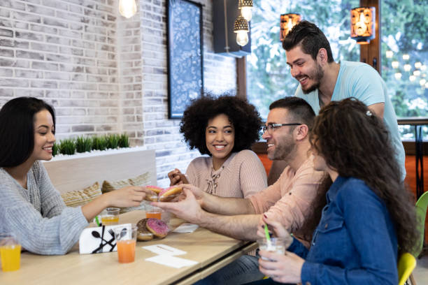 istock Coworkers eating desserts in a bar 1206251585