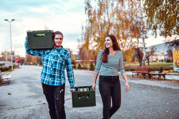 Couple And Their Massive Beer Load On The Way To A Party Couple And Their Massive Beer Load On The Way To A Party beer crate stock pictures, royalty-free photos & images