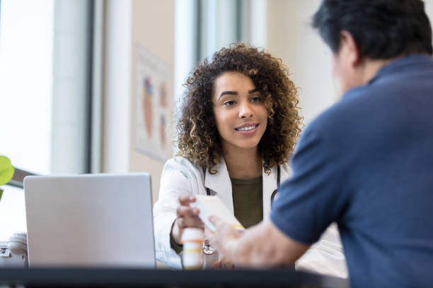 istock Female doctor smiles as patient asks question about medicine 1206252747