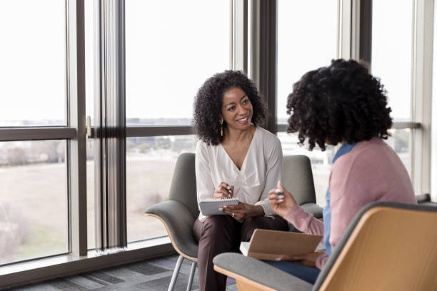 istock Female psychiatrist takes notes while unrecognizable client shares 1206255545