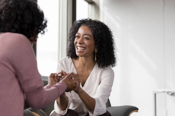 istock Client and therapist hold hands and rejoice at breakthrough 1206255547