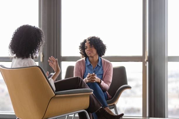 istock Unrecognizable counselor gestures and speaks while female client listens 1206255553