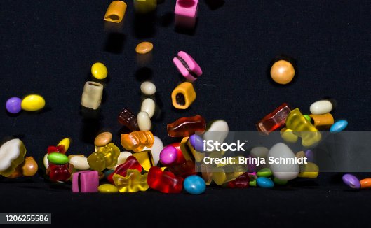 istock Many sweet and colourful candies and wine gums are falling down to the table 1206255586