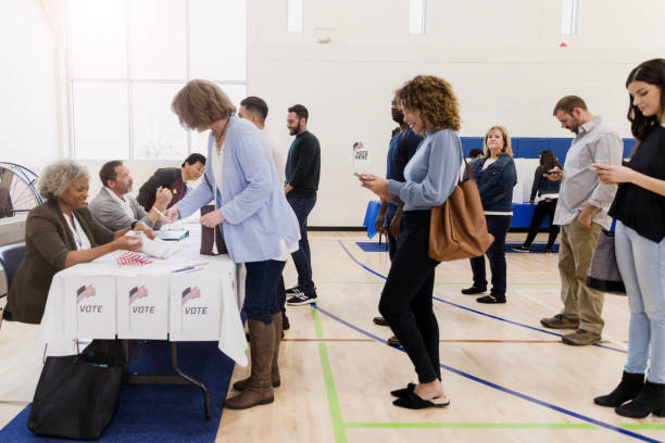 istock People use smartphones while waiting to vote 1206255617