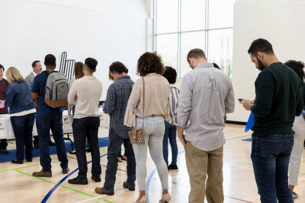 istock Long line of voters in polling place 1206255692