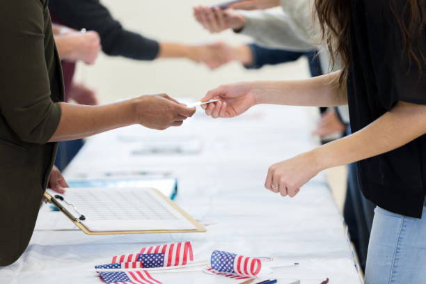 istock Polling place volunteer assists voter during election 1206255698