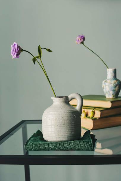 istock Retro home decor: a stack of books, flower in a vase 1206259953