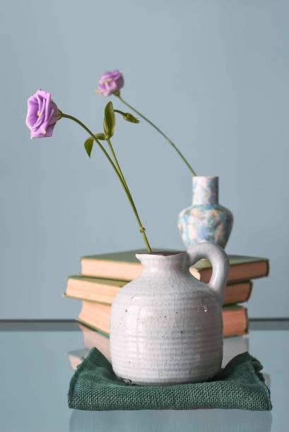 istock Retro home decor: a stack of books, flower in a vase 1206260051