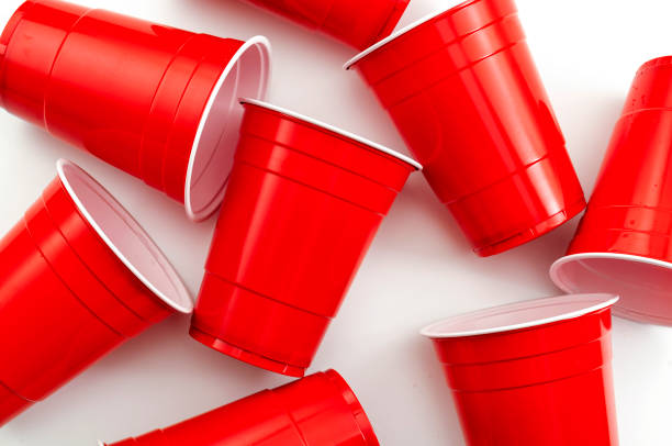 College party and beer pong concept with red drinking plastic cups on white background College party and beer pong concept with red drinking plastic cups on white background red party cup stock pictures, royalty-free photos & images