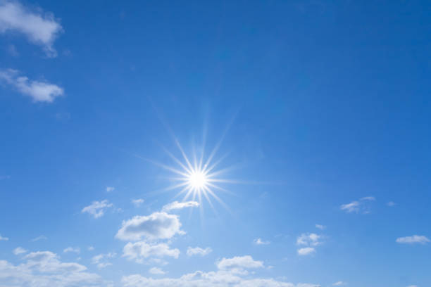 istock sparkle sun in a blue cloudy sky, outdoor sky background 1206260218