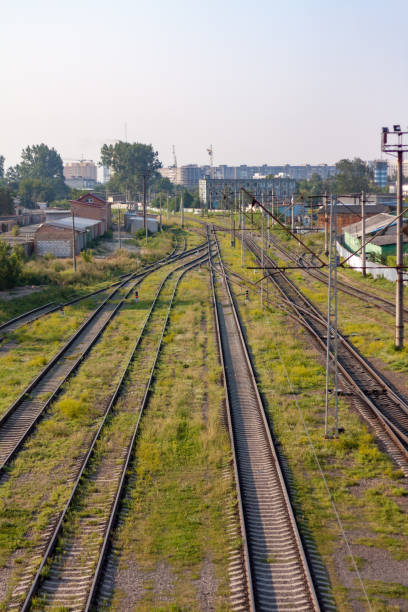 istock Urban railroad landscape with rails following into the frame. 1206260249