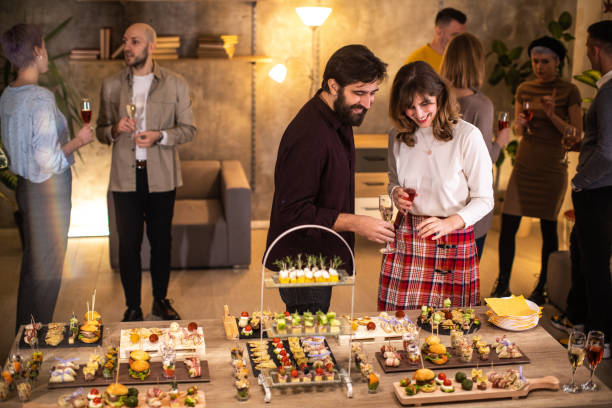 istock Happy colleagues choosing what appetizer to eat at dinner party 1206260578