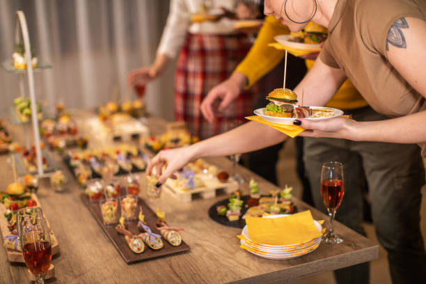 istock Business woman taking appetizer form table at after work dinner party 1206260601