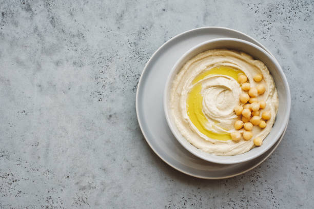 istock Hummus plate with olive oil and chickpeas. Gray background. Copy space 1206261749