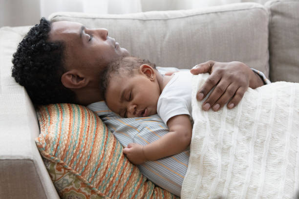 istock Father and daughter sleeping on the sofa 1206262103