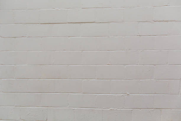 istock Beige rough textured painted cement concrete block wall 1206265651