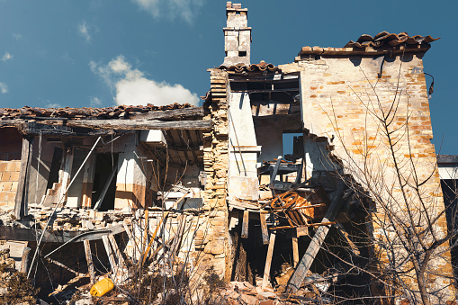 Dilapidated brick farm house, fallen walls, exterior view
