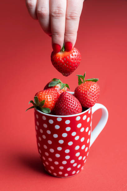'Love', written with strawberries, isolated on white