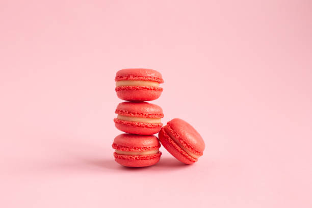 istock Tasty french macaroons on a pink pastel background. 1206268258