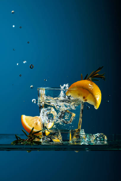 istock Cocktail gin-tonic with lemon and rosemary on a glass table. 1206268298