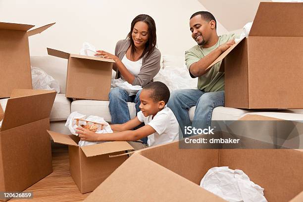 African American Family Unpacking Boxes Moving House Stock Photo - Download Image Now