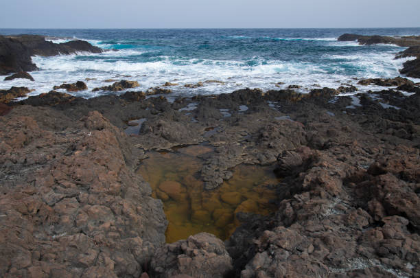Gran Canaria, La Isleta peninsula, volcanic rock formations by the ocean shore
