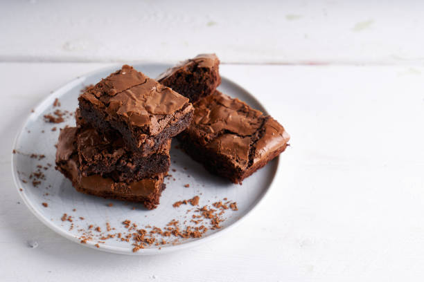 istock Pieces of brownie cake served on a white table Chocolate cake 1206271391