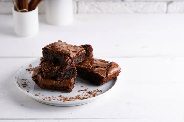 istock Pieces of brownie cake served on a white table Chocolate cake 1206271401
