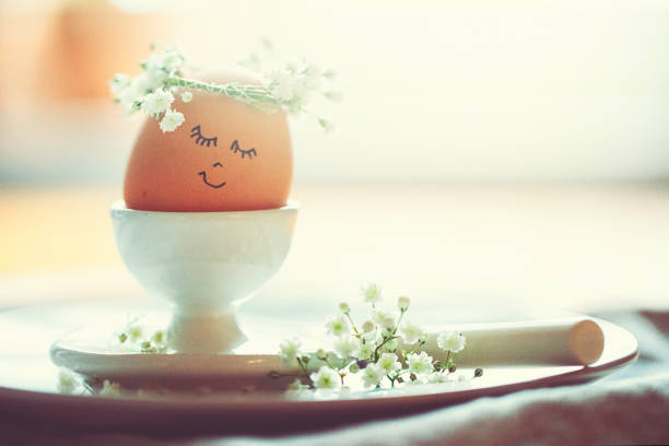 Boiled egg on small plate with fork