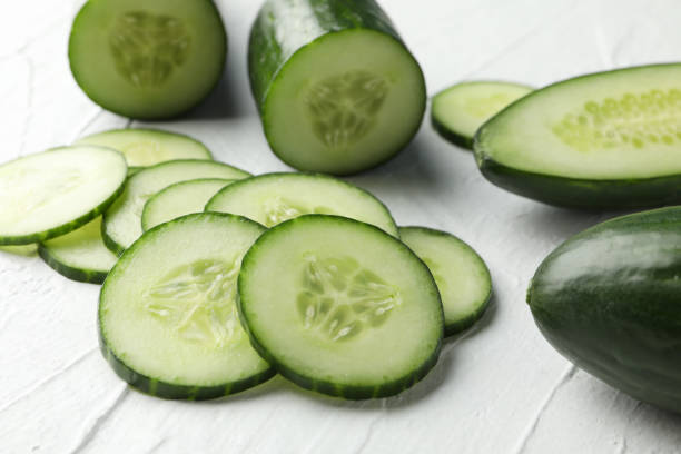 istock Cucumbers and slices on white background, close up 1206272533