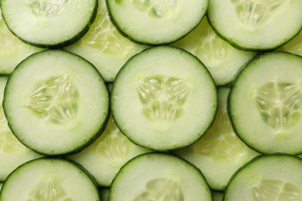 istock Fresh cucumber slices texture background, close up 1206273907