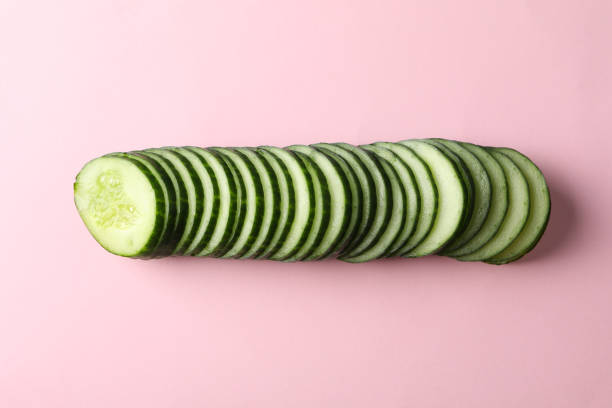 istock Cucumber slices on pink background, space for text 1206274427