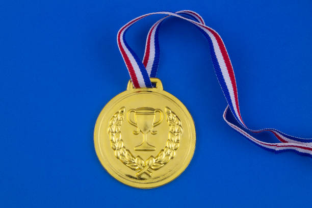 istock Gold medal on blue background 1206275875