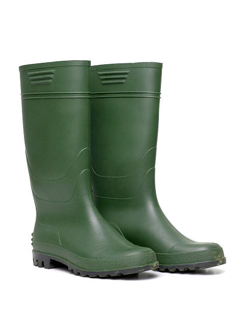 Dark green gumboots on white background Green rubber boots isolated on white background. rubber boot stock pictures, royalty-free photos & images