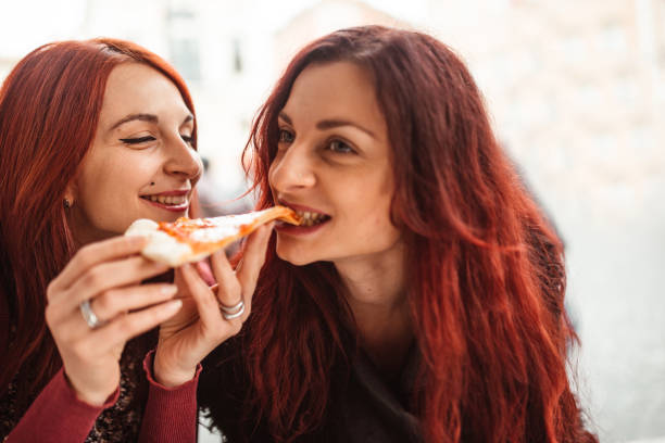 istock friends at the cafe eating a pizza 1206281832