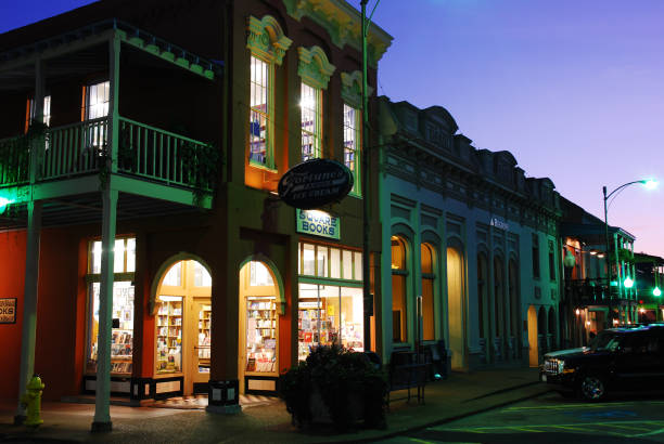 Square Books, in Oxford, Mississippi Oxford, MS, USA July 21 Square Books, a famed independent book store, glows against the dusk sky in Oxford, Mississippi oxford mississippi photos stock pictures, royalty-free photos & images