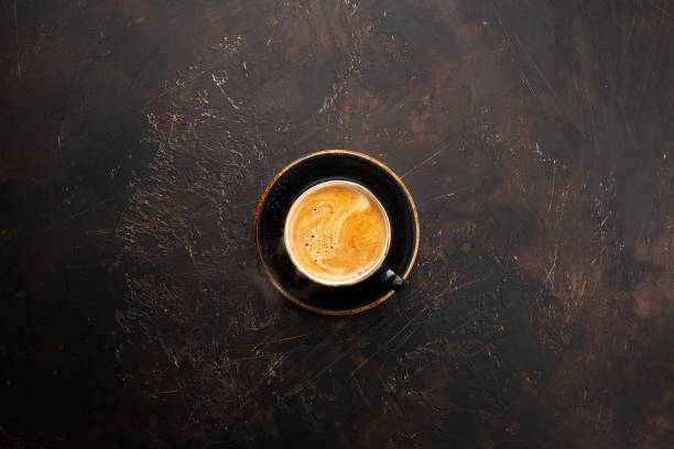 istock Fresh coffee in black mug with plate on dark brown background 1206284464