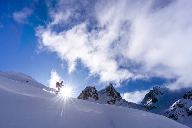 istock Ski mountaineer ascends snowy mountain ridge line 1206294732