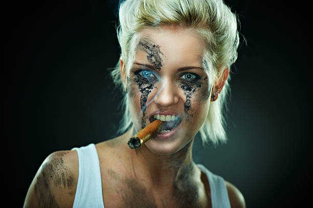 Beautiful young caucasian woman with cigar in mouth stock photo