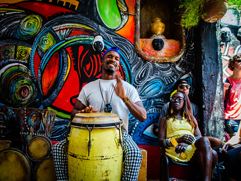 Havana - April 29, 2018: An unknown young man plays the conga drum during a Sunday presentation in the picturesque Hammel Alley placed in Centro Habana, Cuba, on April 29, 2018.