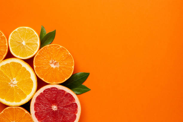 istock Citruses fruits on orange background with copyspace, fruit flatlay, summer minimal compositon with grapefruit, lemon, mandarin and orange 1206298893