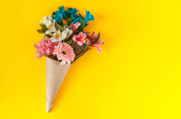 Bouquet of spring flowers A bouquet of fresh spring flowers on the bright yellow background. Top view of spring floral background with copy space get well soon bouquet stock pictures, royalty-free photos & images