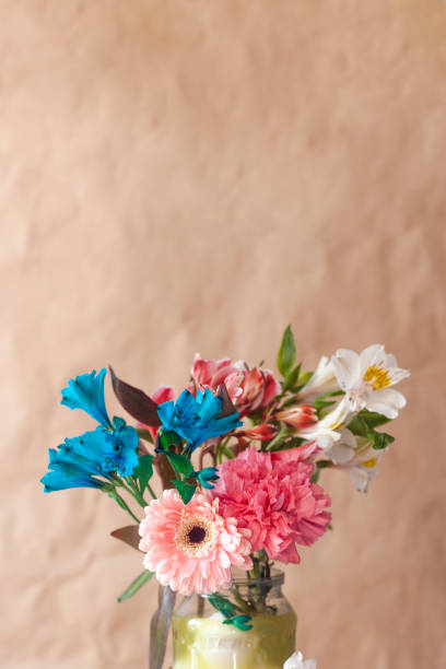 istock A glass jar full with colorful spring flowers 1206304064