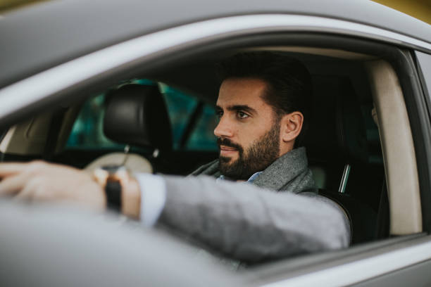 istock Business man is driving car 1206305281