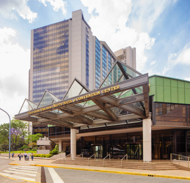 Buenos Aires Sheraton convention Center main entrance and hotel with a few people on the sidewalk.