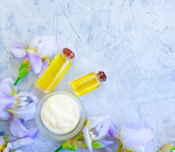 istock cosmetic cream, iris flower oil on concrete background 1206309081